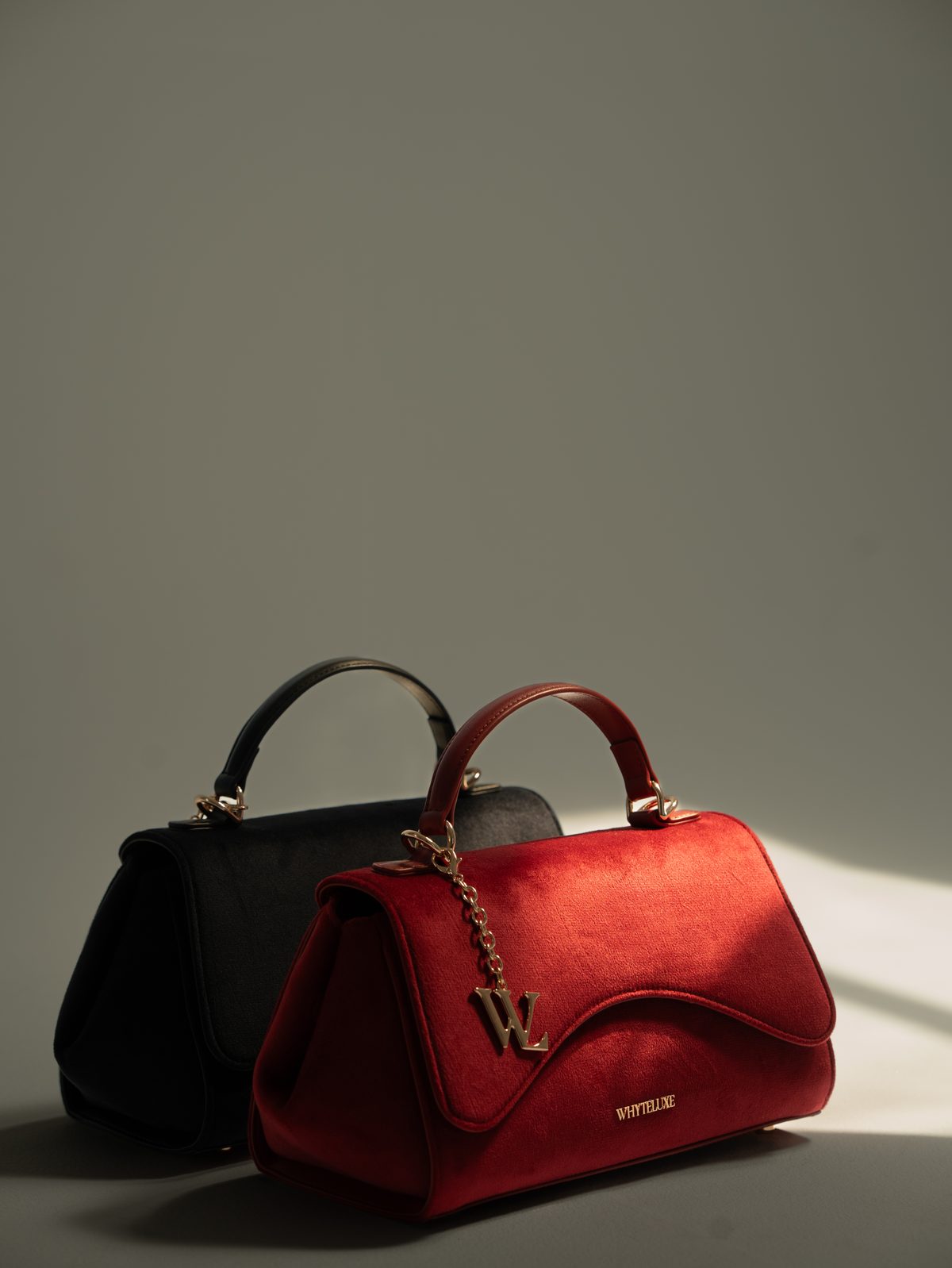 The Becoming in Rouge and Noir with a gold WL charm